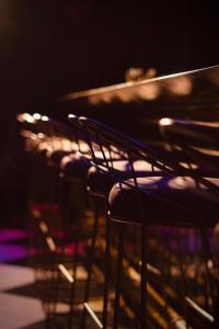 a row of chairs in a dark room at Hush Hush in Barranquilla