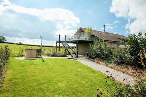 a house with a glass roof and a yard at Luxury Devon Hayloft with panoramic Dartmoor views in Ilsington