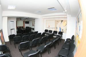 an empty room with chairs and a podium at Pensiunea Studio in Bacău