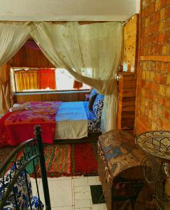 a bedroom with two beds and a table and a chair at Dar Merzouga Meknes in Meknès