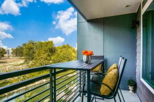 a table and chairs on a balcony with a view at Modern Luxury Condo on Riverwalk #1335 in San Antonio