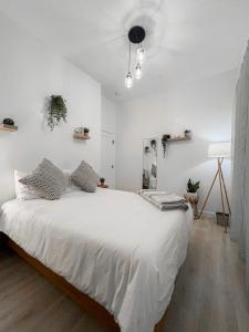 a white bedroom with a large bed in it at Modern 3BR Oasis Free Parking in Oakland