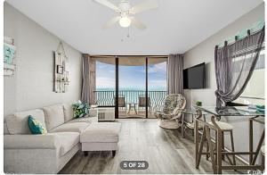 a living room with a couch and a table at Lifes a beach on Myrtle Beach in Myrtle Beach