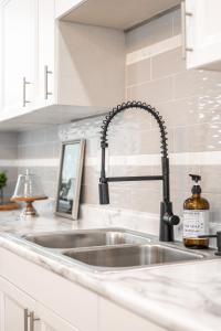 a kitchen counter with a sink in a kitchen at Charming Indianapolis Home~5 Min to Lucas Oil in Indianapolis +92 photos