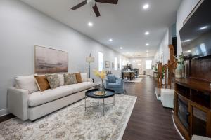 a living room with a couch and a table at Charming Indianapolis Home~5 Min to Lucas Oil in Indianapolis