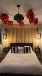 a bedroom with a large white bed with red lanterns at The Cwtch,Self Contained Coastal Annex Freshwater in Freshwater