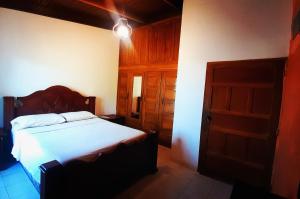 a bedroom with a bed and an open door at Casa Vieja Hotel y Restaurante in San Lorenzo