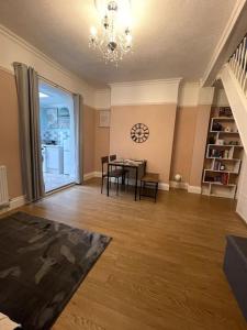 a living room with a table and a dining room at Comfy home in Newport in Newport