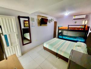 a small room with a bunk bed and a mirror at Habitación amplia independiente en Riohacha in Ríohacha