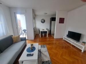 a living room with a couch and a table at Apartment Rony in Zagreb
