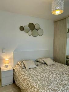 a bedroom with a bed with four mirrors on the wall at Appartement 10 mn de Paris et 5 mn du terminus Paris-Bauvais in Saint-Denis +18 photos