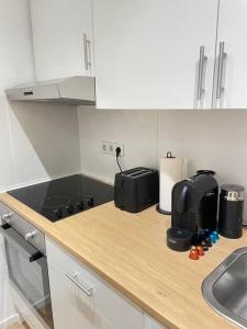 a kitchen with a counter top with a sink and a stove at Moderne Wohnung in Unna Mitte in Unna