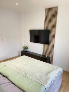 a bedroom with a bed and a flat screen tv at Moderne Wohnung in Unna Mitte in Unna