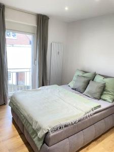 a large bed in a room with a window at Moderne Wohnung in Unna Mitte in Unna