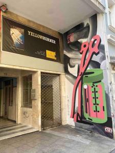 a building with a wall with a painting on it at STM Monastiraki Acropolis Apt in Athens