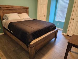 a bed in a room with a wooden bed frame at Best spot for you and the family in Sevier County in Pigeon Forge