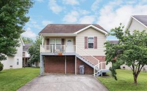 a house with a staircase in the front of it at Best spot for you and the family in Sevier County in Pigeon Forge