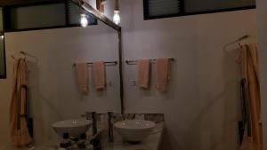a bathroom with two sinks and towels on the wall at REFUGIO LA CASONA in Cucaita