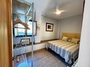 a small bedroom with a bed and a glass ladder at LOS PINOS DE NAVALFRESNO in Aracena