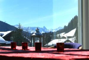 een kamer met een tafel en uitzicht op een berg bij The Holiday Home Davos in Davos