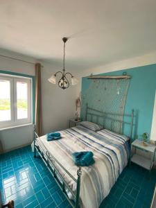 Villa Asinara في ستينتينو: غرفة نوم مع سرير في الطابق الأزرق