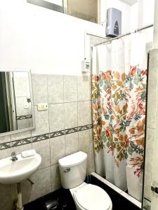 a bathroom with a toilet and a sink at Morada Apart in Tacna