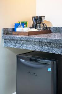 a counter top over a refrigerator under a counter at Golden Bay Belize Hotel in Belize City