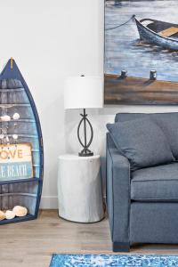 a living room with a couch and a table at Seas The Day Saratoga at THE BEACH HOUSE in Campbell River