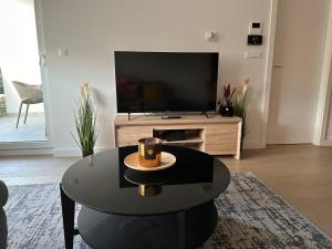 a living room with a coffee table and a flat screen tv at Apartment Rhea SelfCheckIn Garage Loggia New in Zagreb