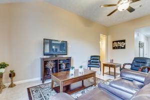 a living room with a couch and a tv at Houston Blue House in Houston