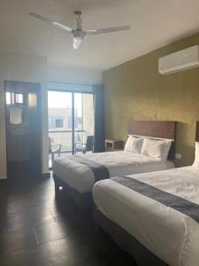 Giường trong phòng chung tại REGMAR Progreso Yucatán