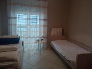 a small bedroom with a bed and a small table at FAMILY HOUSE in Modugno