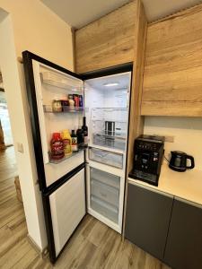 a refrigerator with its door open in a kitchen at Chata pod Starou Horou in Trstená
