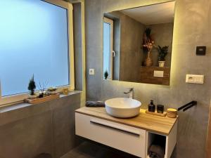 a bathroom with a sink and a large mirror at Chata pod Starou Horou in Trstená