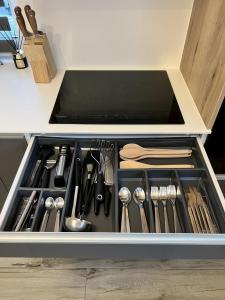 a drawer filled with utensils in a kitchen at Chata pod Starou Horou in Trstená
