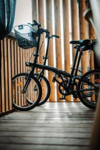 a bike with a basket parked on a wooden floor at SEA HOUSE pool & jacuzzi, bikes, SUP - PRIVILEGE POINT camping & villas in Selce