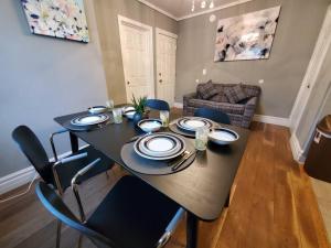 a table in a living room with a dining room at Modern Getaway, Single Bedroom Full Apartment in Niagara Falls