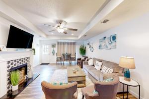 a living room with a couch and a fireplace at Amazon Riviera in Foley