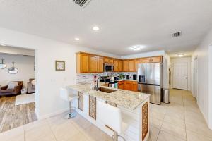 a kitchen with wooden cabinets and a counter top at Amazon Riviera in Foley