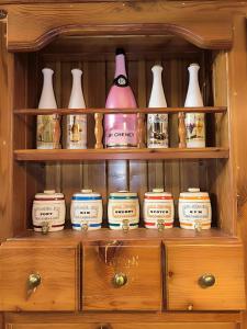 a cabinet filled with lots of vases and jars at Il figolla farmhouse in Xagħra