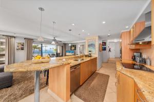 a kitchen with a counter with a bowl of fruit on it at Kaanapali Alii 255 in Lahaina