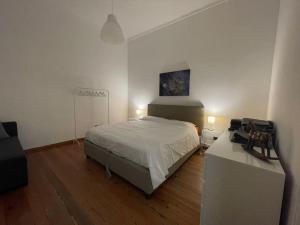 a bedroom with a bed and a desk with a printer at Appartamento centro storico in Via Palestro in Ivrea
