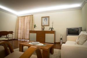 a living room with a couch and a table at 2 bedrooms appartement with wifi at Camara De Lobos 4 km away from the beach in Funchal