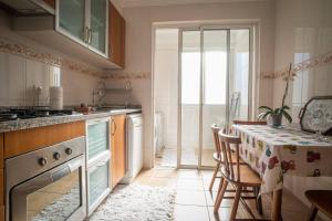 a kitchen with a table with a table cloth on it at 2 bedrooms appartement with wifi at Camara De Lobos 4 km away from the beach in Funchal