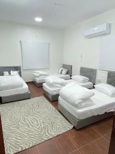 a room with four mattresses on the floor at Alfatih apartments شقة الفتح in Al Madinah