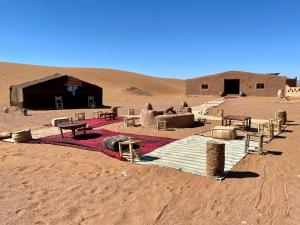 a group of huts in the desert at Erg Chegaga Desert Night in El Gouera