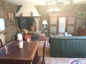 a living room with a couch and a table at 5 bedrooms chalet with terrace and wifi at Parada in Portas