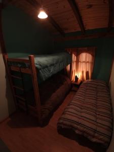 a bedroom with two bunk beds in a room at Cabañas Don Carlos in El Hoyo