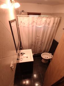 a bathroom with a sink and a shower curtain at Cabañas Don Carlos in El Hoyo