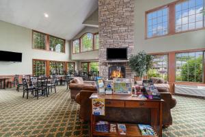 a living room with couches and a fireplace at Howard Johnson by Wyndham Traverse City in Traverse City